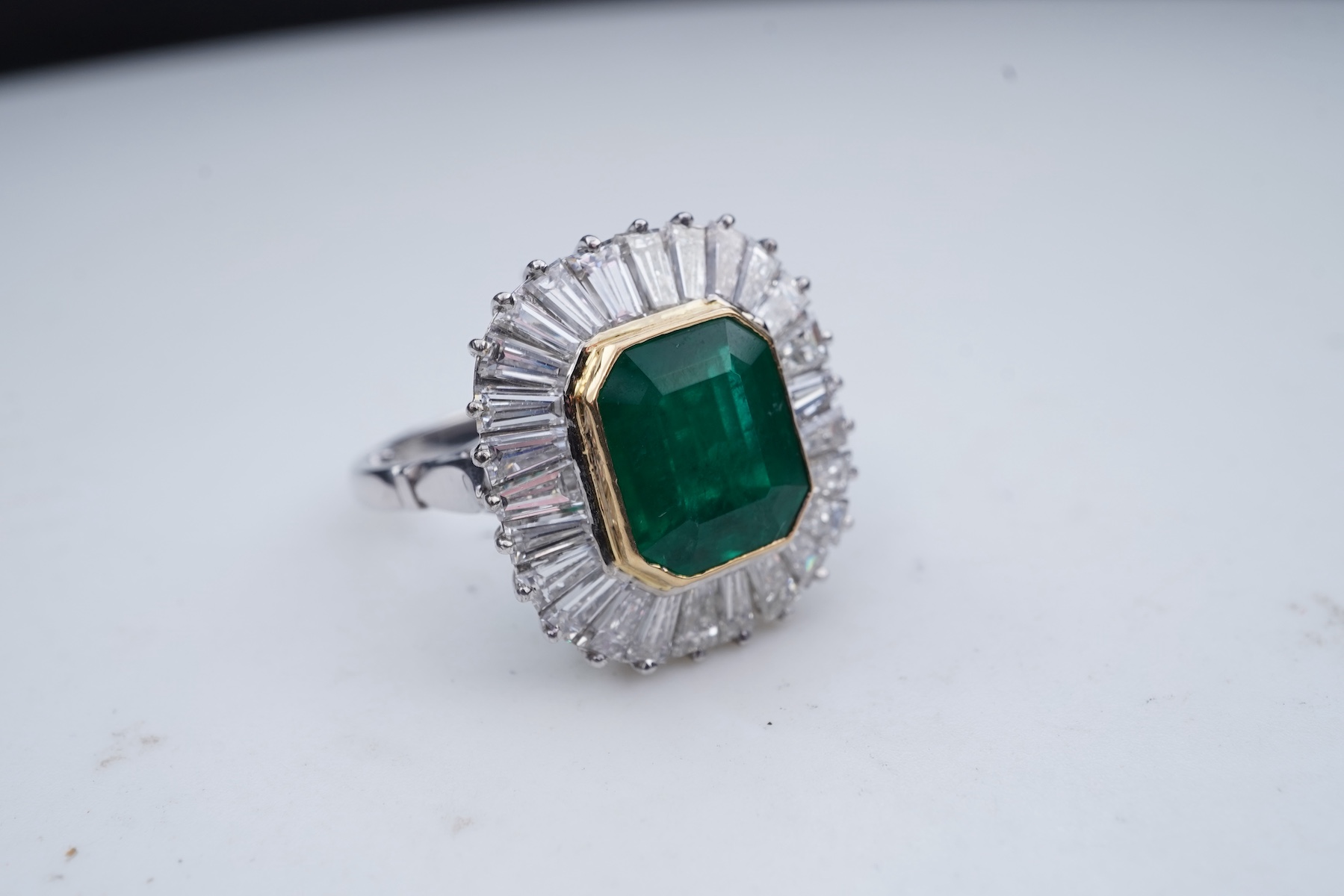 An emerald and diamond ring